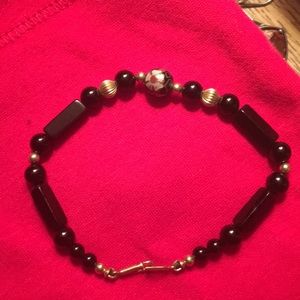 Black and gold bracket with flower center bead
